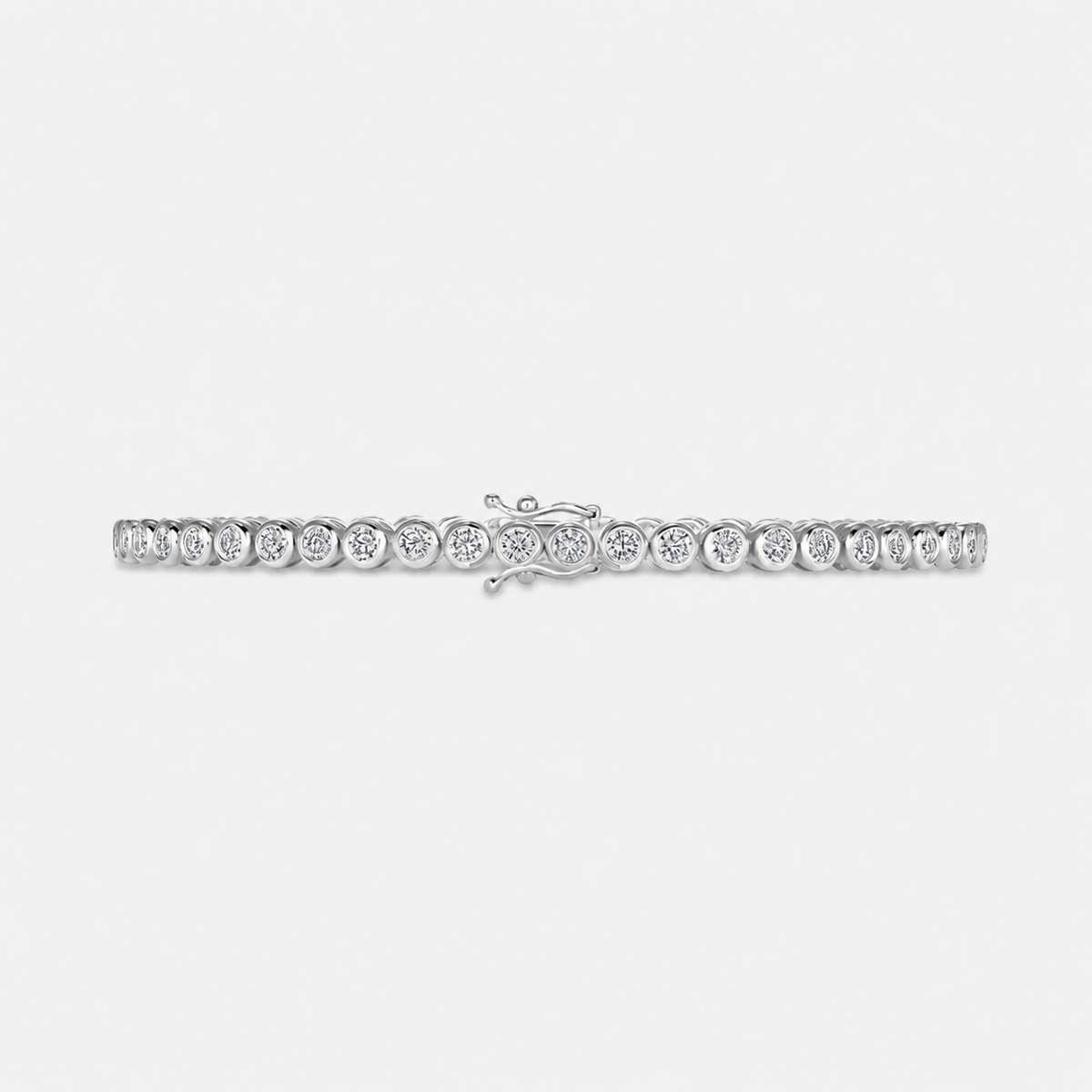 Bezel set lab grown diamond tennis bracelet in 14K white gold, laid flat with the box clasp visible #Metal_White Gold