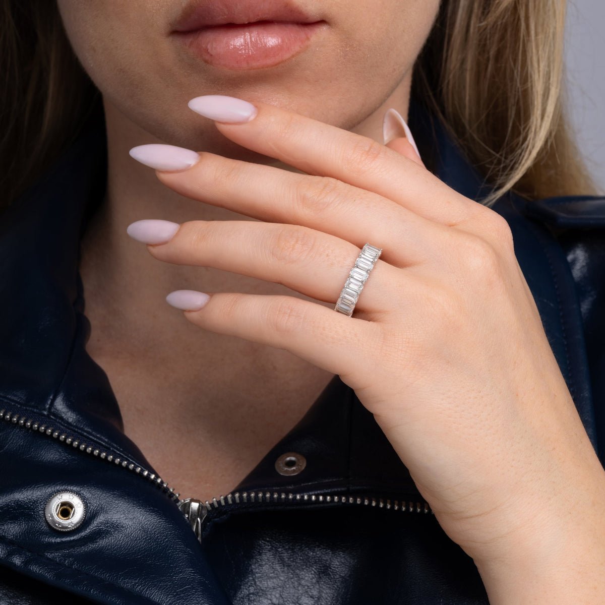 Emerald cut lab grown diamond eternity band worn on the hand, 6.21 carat total weight
