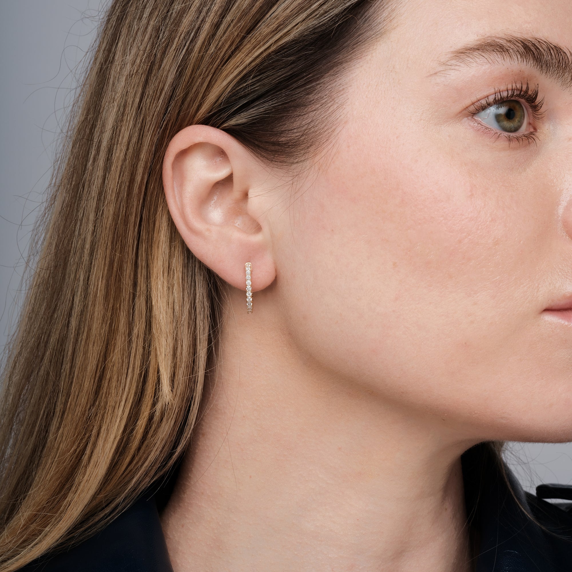 Diamond hoop earrings worn on the ear, 0.85 carat total weight