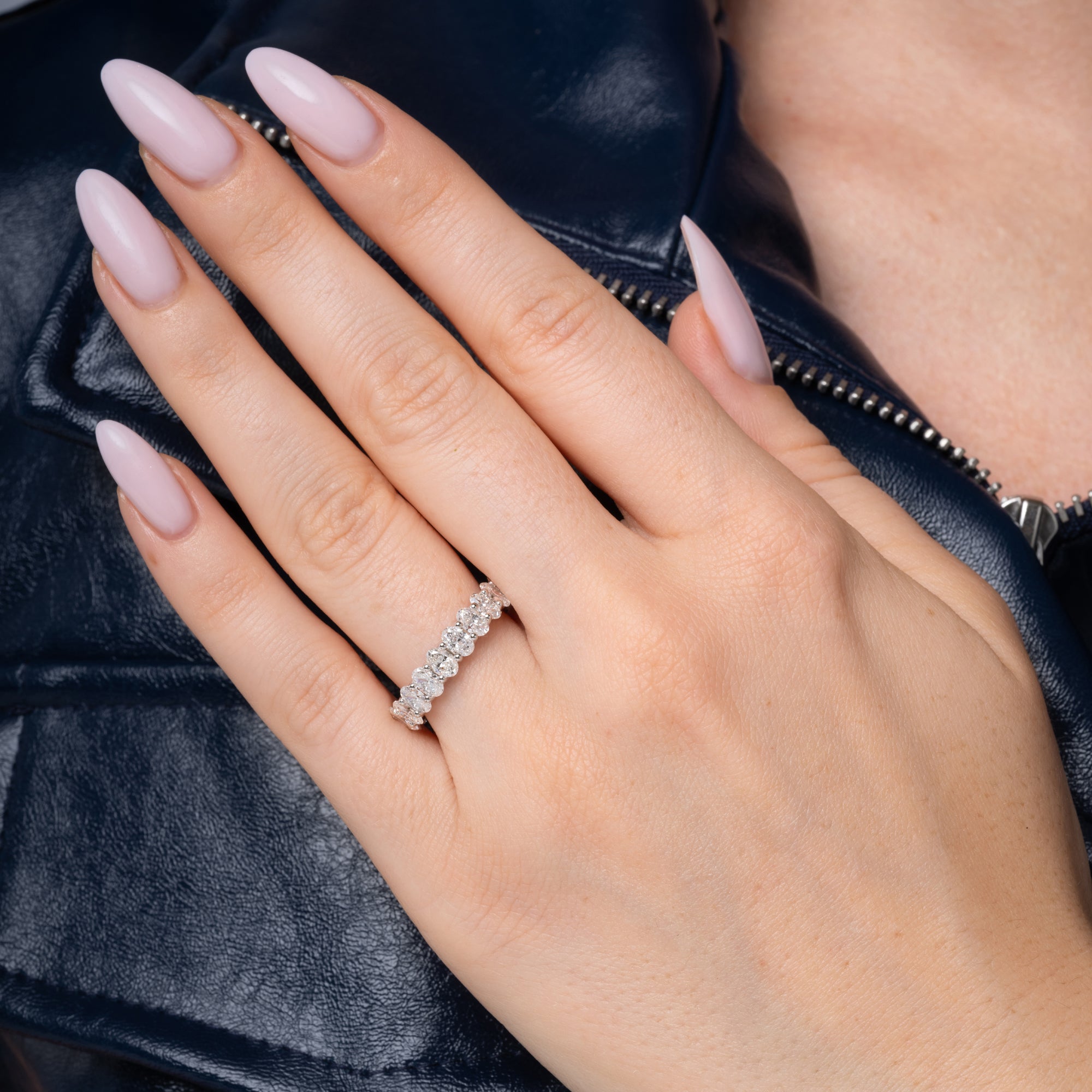 3.62 carat oval diamond eternity band shown on the finger