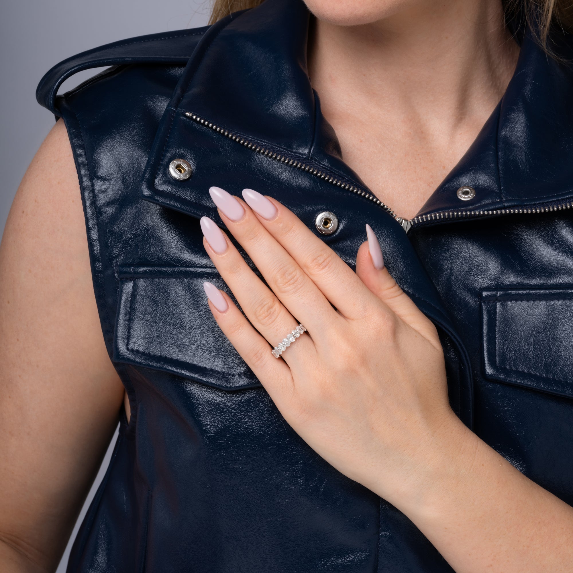 Oval diamond eternity band styled on the hand in 14K white gold