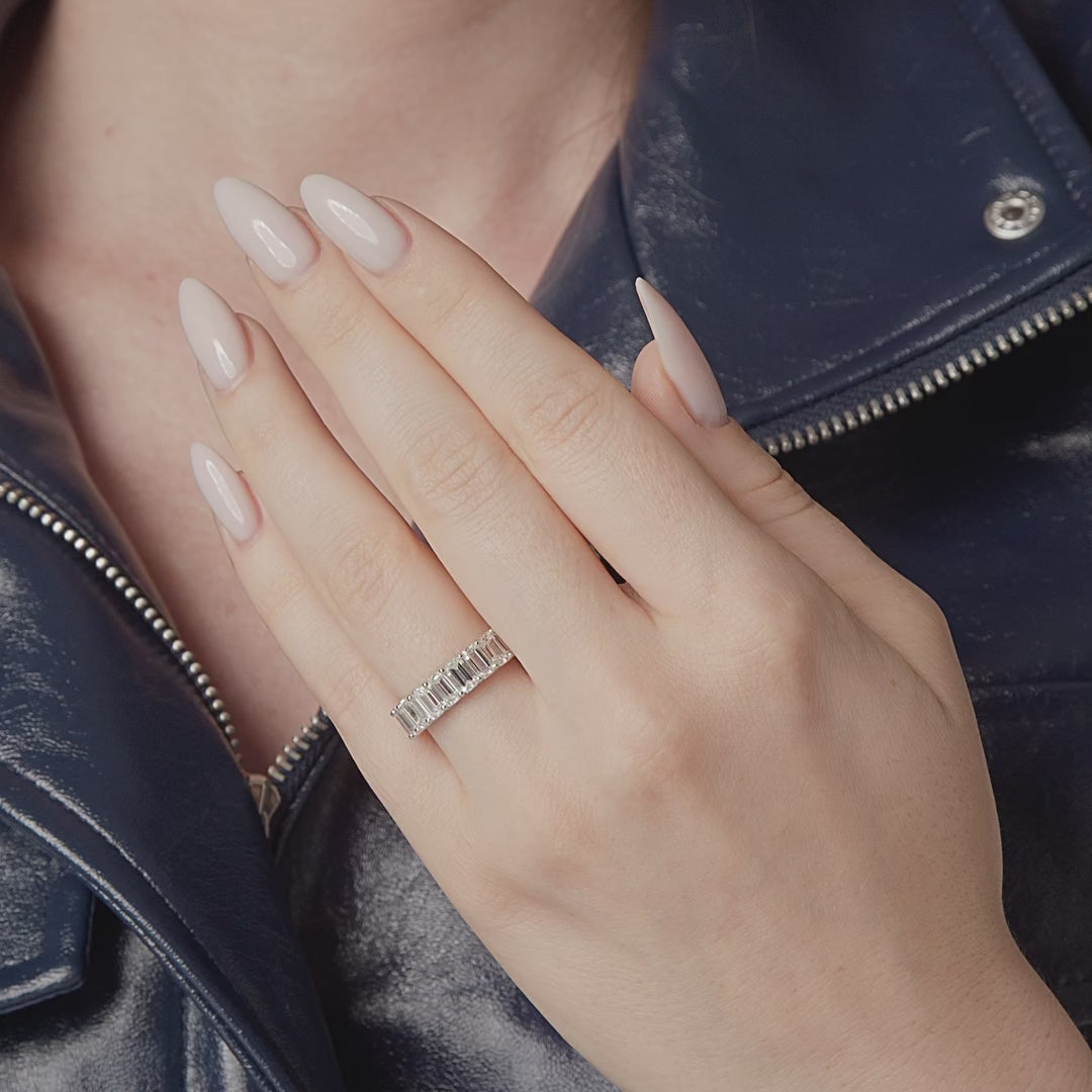 Emerald cut diamond eternity band shown in motion on the hand, 6.21 carat total weight