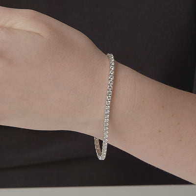 Round diamond tennis bracelet shown in motion on the wrist, 5.30 carat total weight