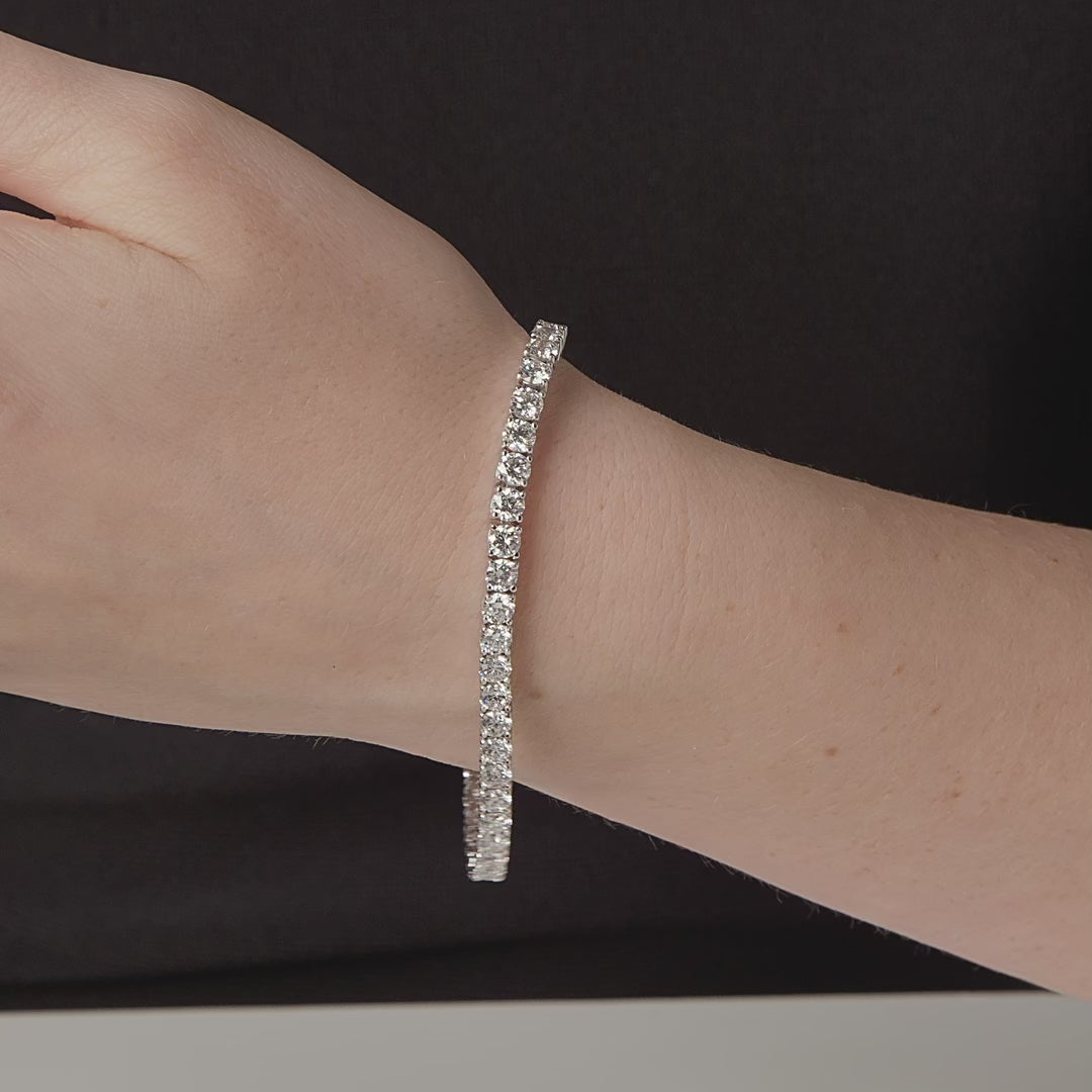 Round diamond tennis bracelet shown in motion on the wrist