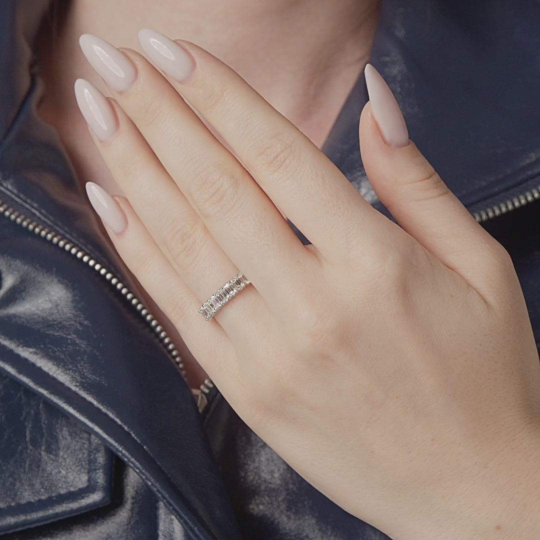 Emerald cut east-west diamond eternity band shown in motion on the hand