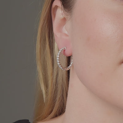 1.78 carat diamond hoop earrings shown in motion on the ear