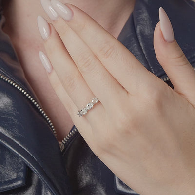 Oval east-west diamond eternity band shown in motion on the hand