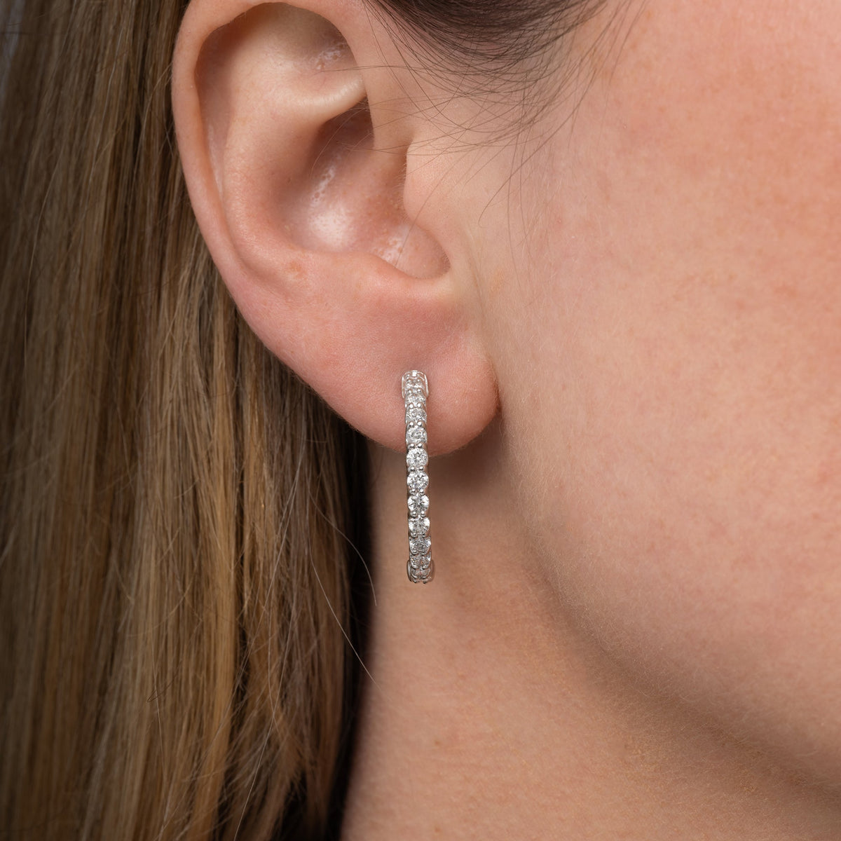 Diamond hoop earrings worn on the ear, 1.78 carat total weight