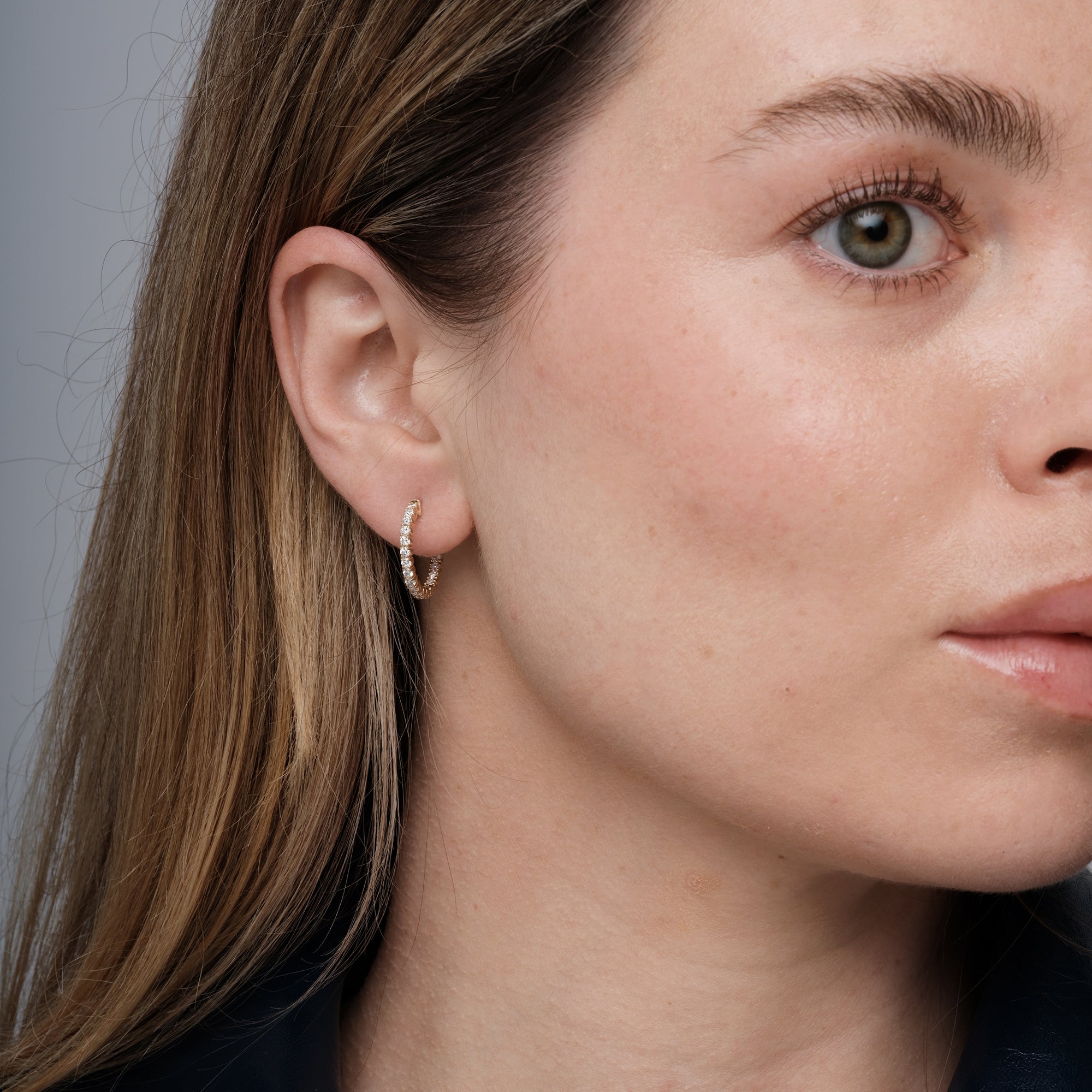 Diamond hoop earrings worn on the ear, 0.85 carat total weight