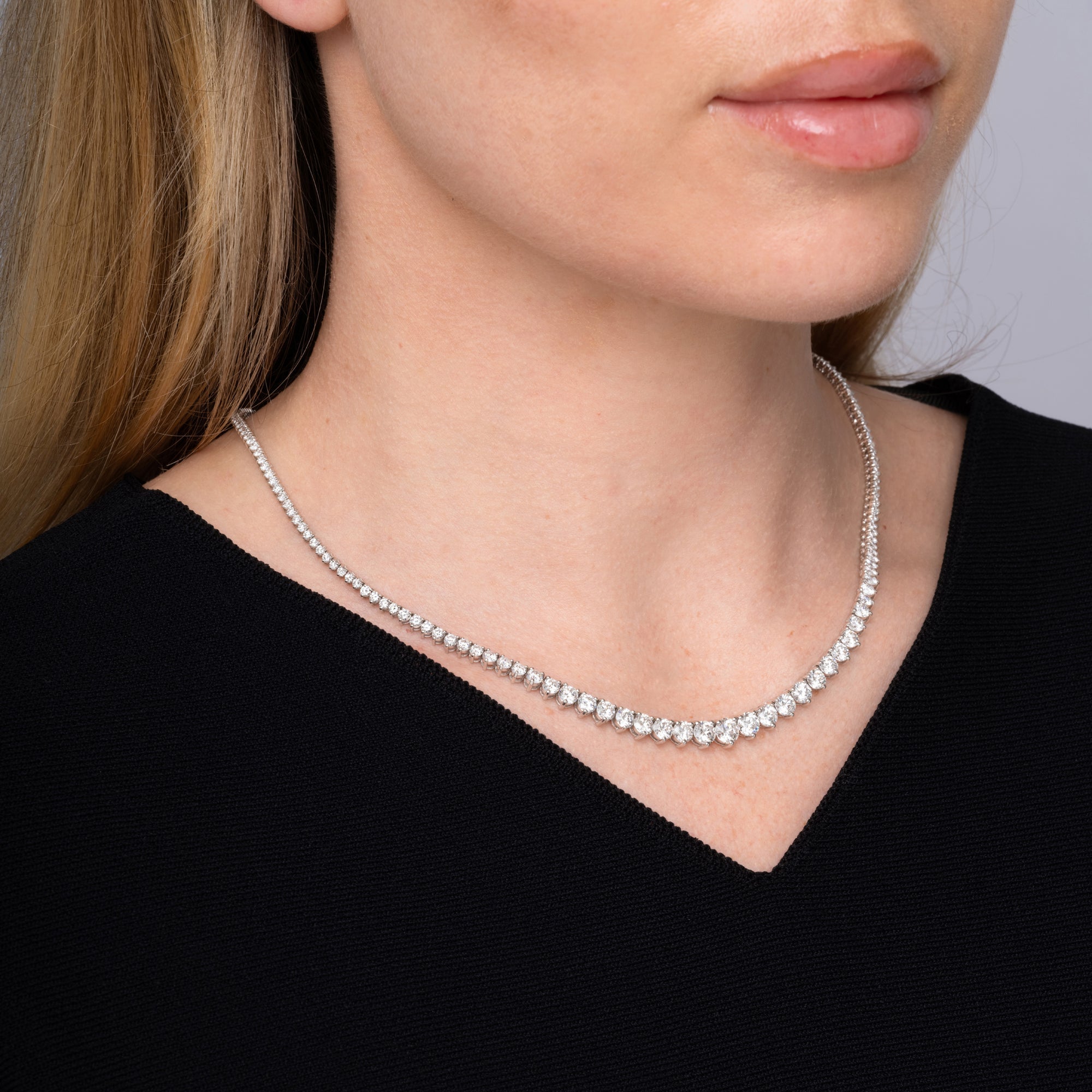 Model wearing a graduated diamond tennis necklace, second angle